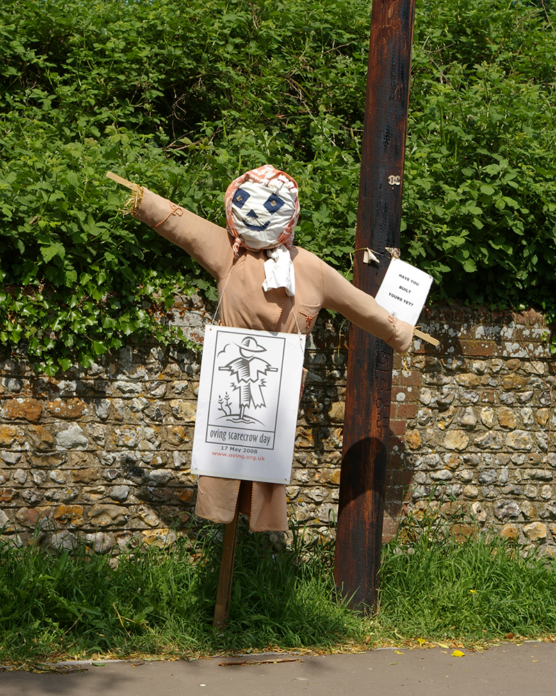 Oving Scare Crow Day scarecrow and sign